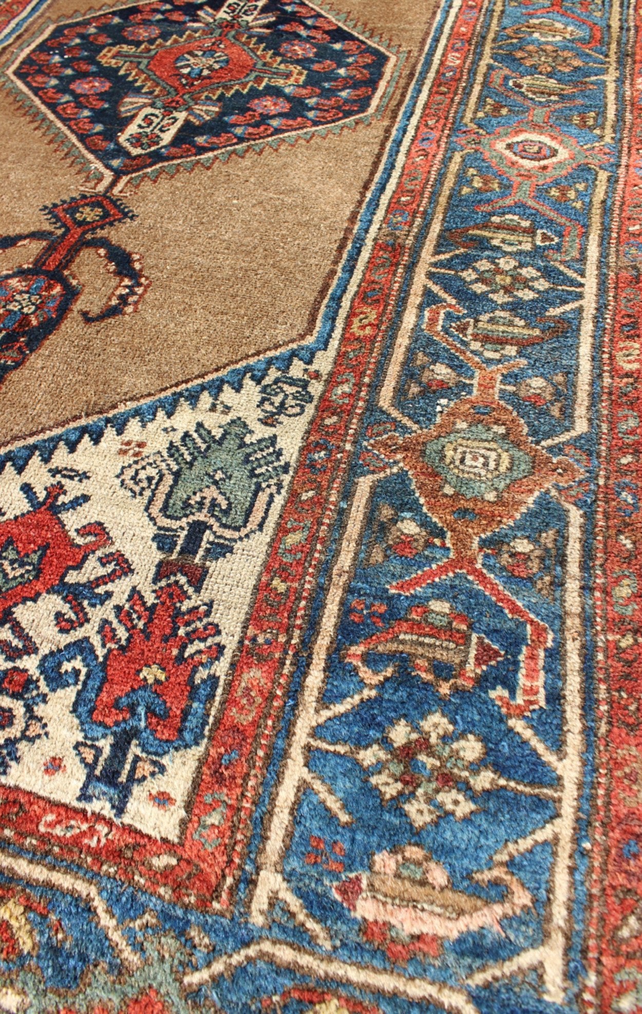 Antique Persian Serab rug with stretched tribal medallion in camel, blue, ivory and red, rug m14 - 0506, country of origin / type: Iran / Serab, circa 1900 This early 20th century, handwoven antique Persian Serab rug features a camel - colored field... - Keivan Woven Arts13 - 0906 - 4790Rug