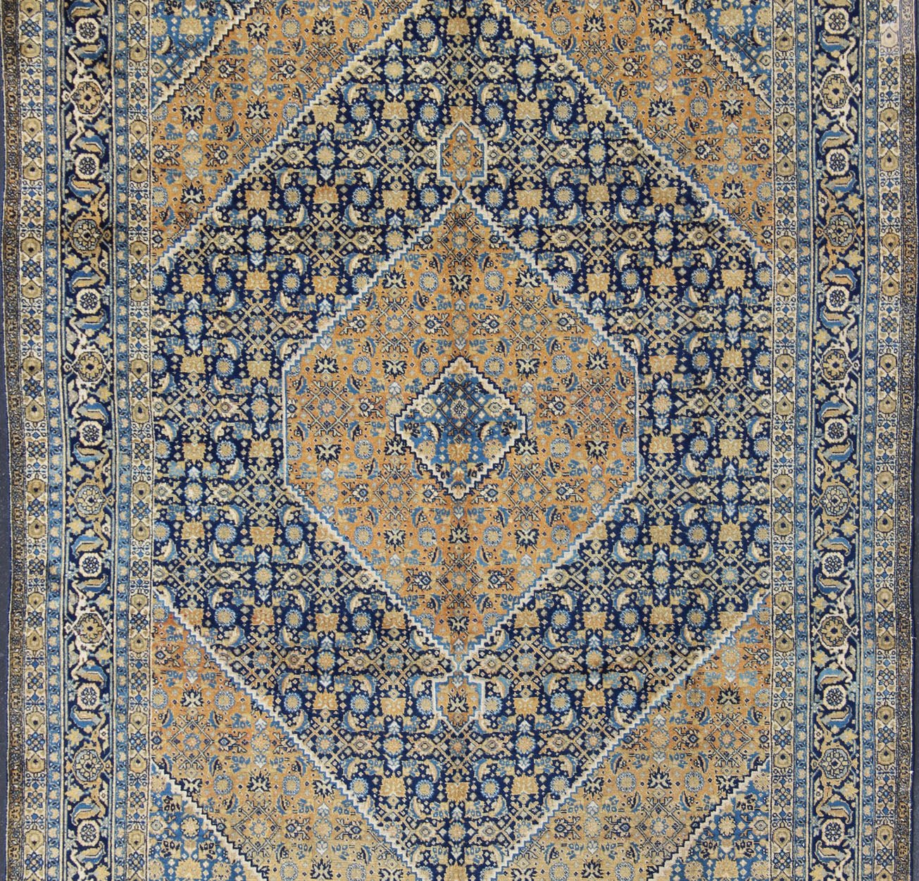 Antique Persian Tabriz Rug with Medallion And A Variety of Blue's and Gold's. Keivan Woven Arts / Rug / 16 - 1205, country of origin / type: Iran / Tabriz, circa 1920. Classic geometric Tabriz. Measures: 9'3 x 12'5. This antique Persian Tabriz rug ... - Keivan Woven Arts16 - 1205 - 8151Rug