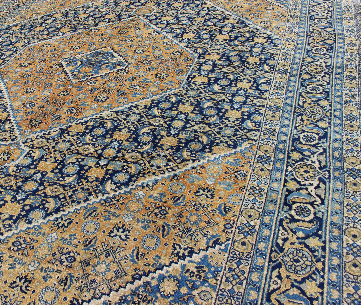 Antique Persian Tabriz Rug with Medallion And A Variety of Blue's and Gold's. Keivan Woven Arts / Rug / 16 - 1205, country of origin / type: Iran / Tabriz, circa 1920. Classic geometric Tabriz. Measures: 9'3 x 12'5. This antique Persian Tabriz rug ... - Keivan Woven Arts16 - 1205 - 8151Rug