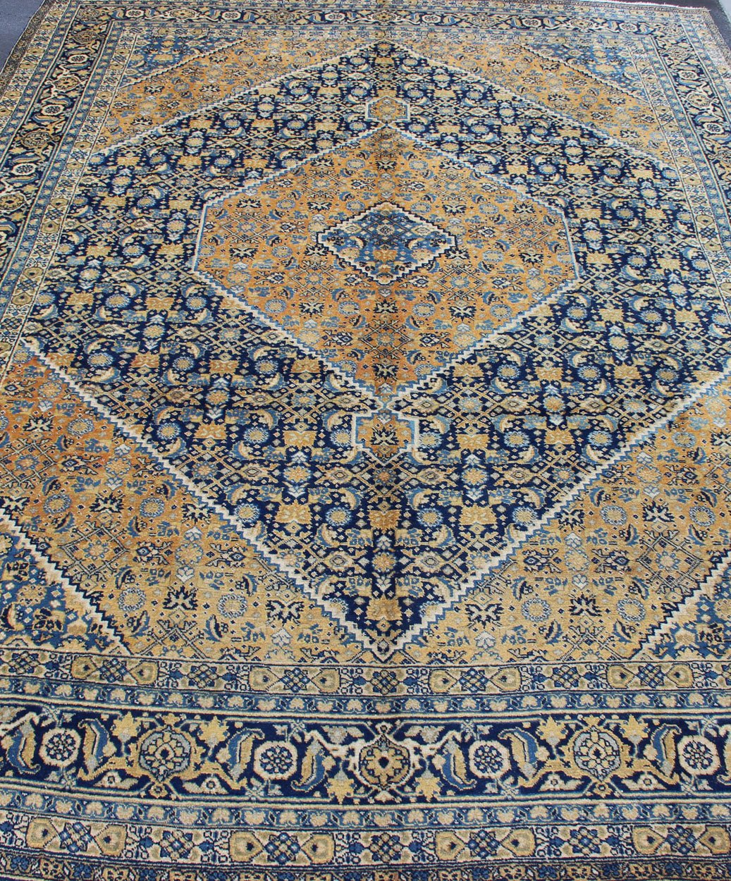 Antique Persian Tabriz Rug with Medallion And A Variety of Blue's and Gold's. Keivan Woven Arts / Rug / 16 - 1205, country of origin / type: Iran / Tabriz, circa 1920. Classic geometric Tabriz. Measures: 9'3 x 12'5. This antique Persian Tabriz rug ... - Keivan Woven Arts16 - 1205 - 8151Rug