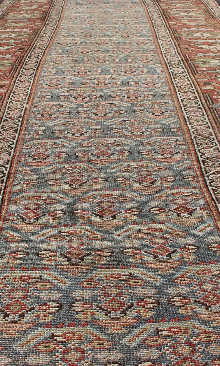 Gray background and soft red - colored Persian Kurdish antique runner in Tribal design with geometric motifs, rug 19 - 0105, country of origin / type: Iran / Kurdish, circa 1900. This antique Kurdish tribal rug was woven by Kurdish weavers in wester... - Keivan Woven Arts19 - 0105 - 11106Rug