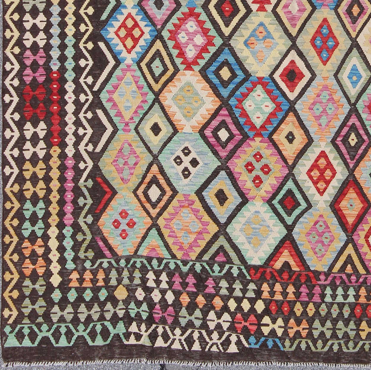 Colorful Tribal Kilim Flat Weave Rug with Chocolate Brown & Bright Multi Colors This flat - woven kilim rug from Afghanistan features a bold geometric design consisting of a variety of colors, including brown, purple, light green, teal, yellow, gr... - Keivan Woven ArtsABT - 8120937 - 8467Rug