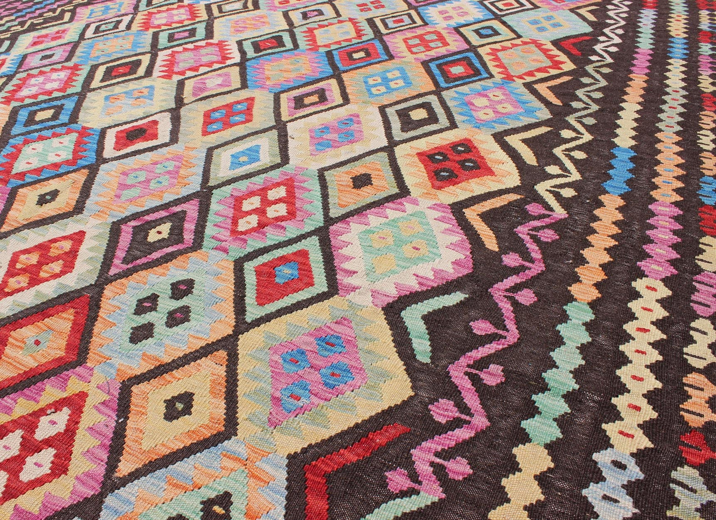 Colorful Tribal Kilim Flat Weave Rug with Chocolate Brown & Bright Multi Colors This flat - woven kilim rug from Afghanistan features a bold geometric design consisting of a variety of colors, including brown, purple, light green, teal, yellow, gr... - Keivan Woven ArtsABT - 8120937 - 8467Rug
