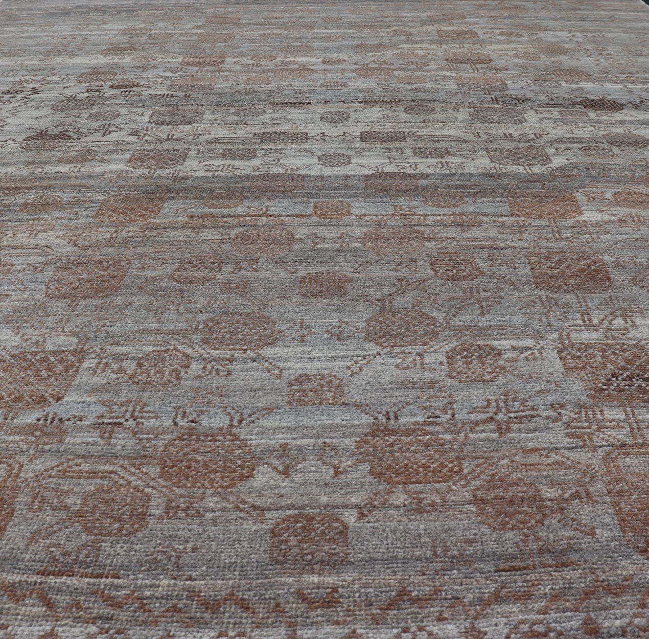 Modern Hand - Knotted Khotan Rug with Sub - Geometric Pomegranate Design This modern casual tribal rug has been hand - knotted. The rug features a modern sub - geometric pomegranate design and is enclosed within a complementary, multi - tiered border, re... - Keivan Woven ArtsAFG - 39680 - 19826Rug