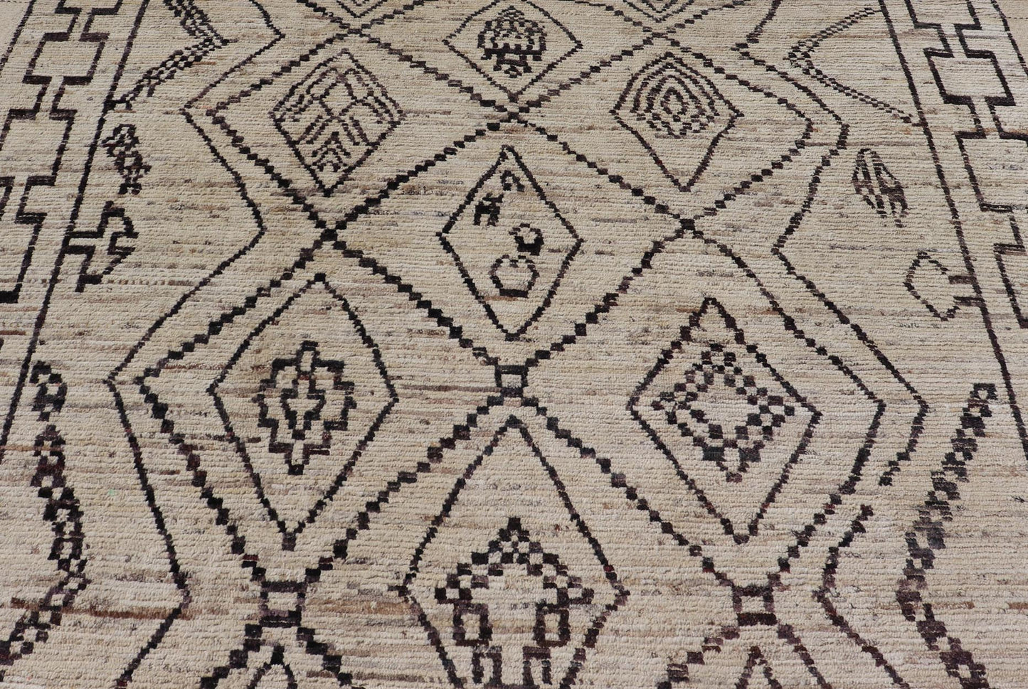 The design of the rug includes a series of interconnected diamond shapes, each containing different motifs such as crosses, zigzags, and other stylized symbols. The central theme is a grid of diamond patterns that vary slightly in size and detail, crea... - Keivan Woven ArtsAFG - 39925 - 19598Rug