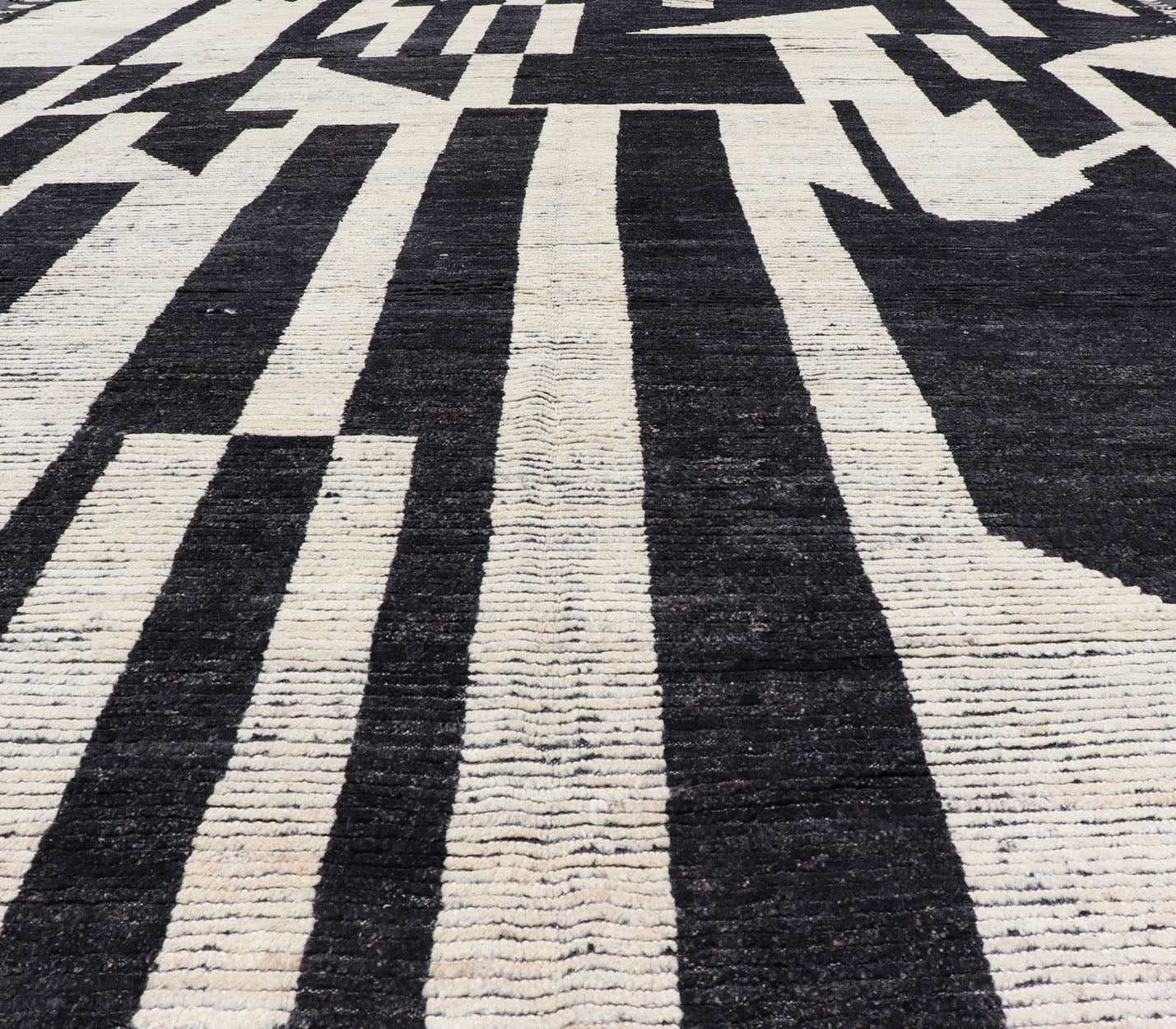 Ebony and Ivory Oversized Abstract Modern Casual This oversized modern casual was hand - knotted in Afghanistan. The field portrays an ivory background disrupted by flashes of ebony abstractions. The small simple border has a crafty ivory embr... - Keivan Woven ArtsAFG - 43436 - 20247Rug