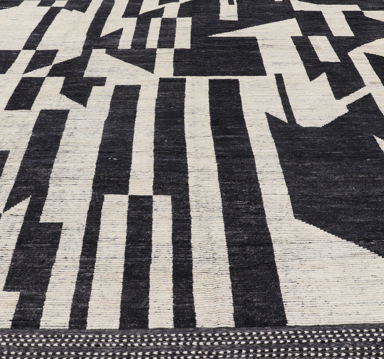Ebony and Ivory Oversized Abstract Modern Casual This oversized modern casual was hand - knotted in Afghanistan. The field portrays an ivory background disrupted by flashes of ebony abstractions. The small simple border has a crafty ivory embr... - Keivan Woven ArtsAFG - 43436 - 20247Rug