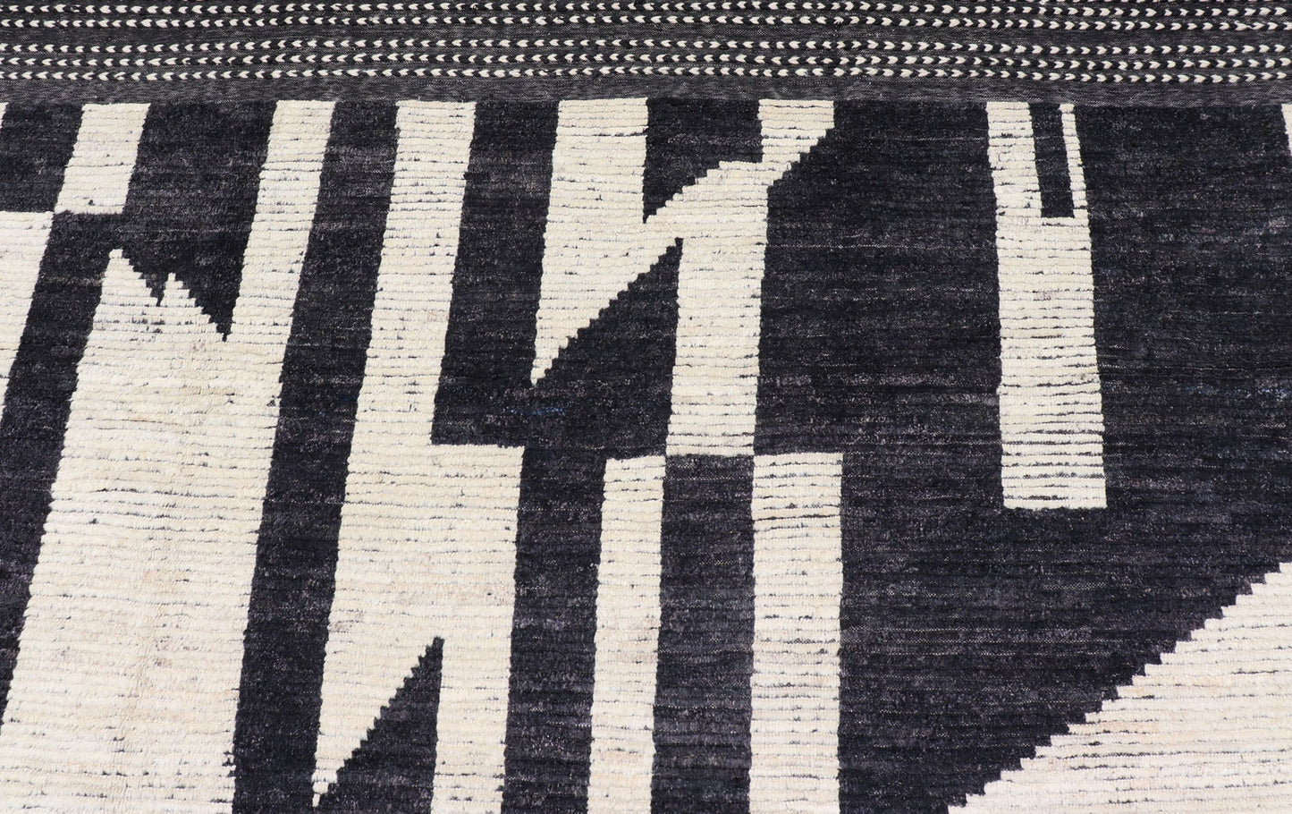 Ebony and Ivory Oversized Abstract Modern Casual This oversized modern casual was hand - knotted in Afghanistan. The field portrays an ivory background disrupted by flashes of ebony abstractions. The small simple border has a crafty ivory embr... - Keivan Woven ArtsAFG - 43436 - 20247Rug