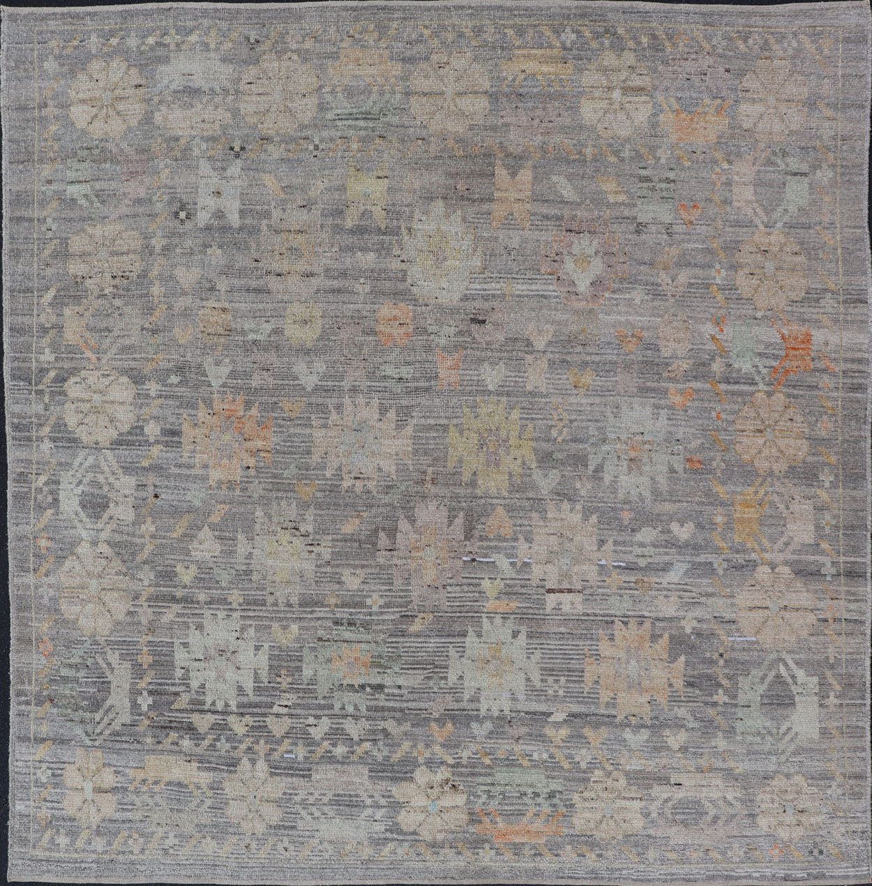 Modern Afghan Tribal Motif Designed Rug in Muted Tones and A Gray Background Measures 7'2 x 8'4 This modern area rug was hand - knotted in Afghanistan during the 2020's. This modern rug does feature a border of modest floral motifs. The gr... - Keivan Woven ArtsAFGC - 39487 - 18565Rug