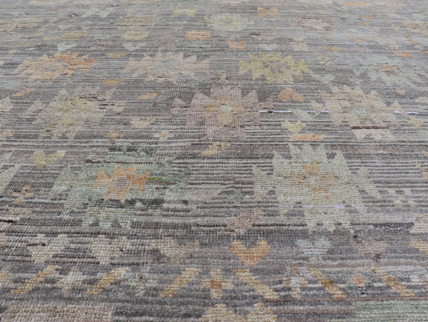 Modern Afghan Tribal Motif Designed Rug in Muted Tones and A Gray Background Measures 7'2 x 8'4 This modern area rug was hand - knotted in Afghanistan during the 2020's. This modern rug does feature a border of modest floral motifs. The gr... - Keivan Woven ArtsAFGC - 39487 - 18565Rug