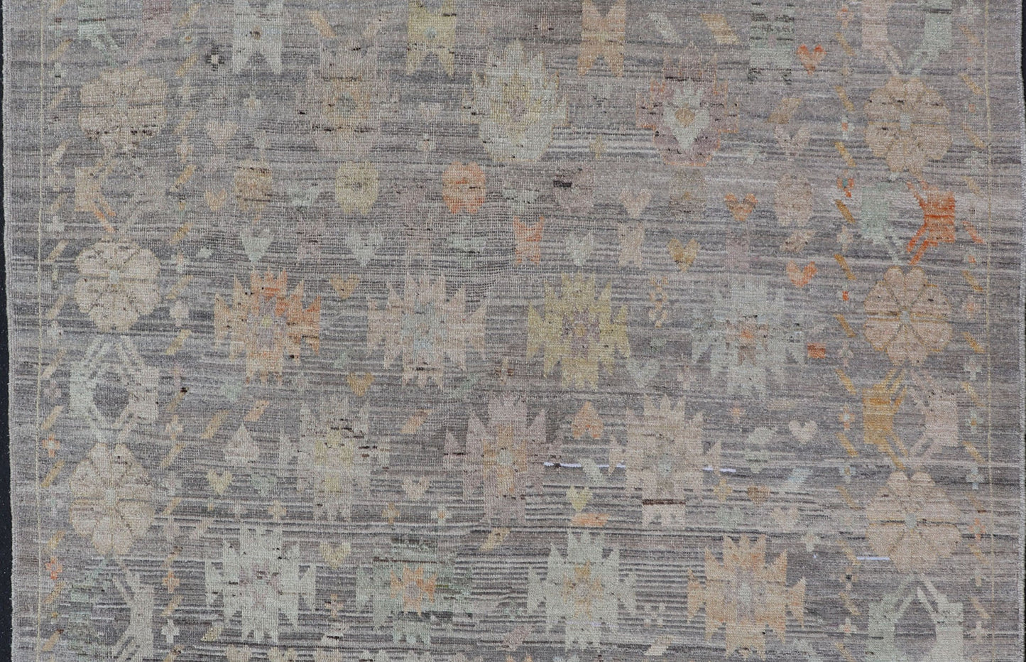 Modern Afghan Tribal Motif Designed Rug in Muted Tones and A Gray Background Measures 7'2 x 8'4 This modern area rug was hand - knotted in Afghanistan during the 2020's. This modern rug does feature a border of modest floral motifs. The gr... - Keivan Woven ArtsAFGC - 39487 - 18565Rug