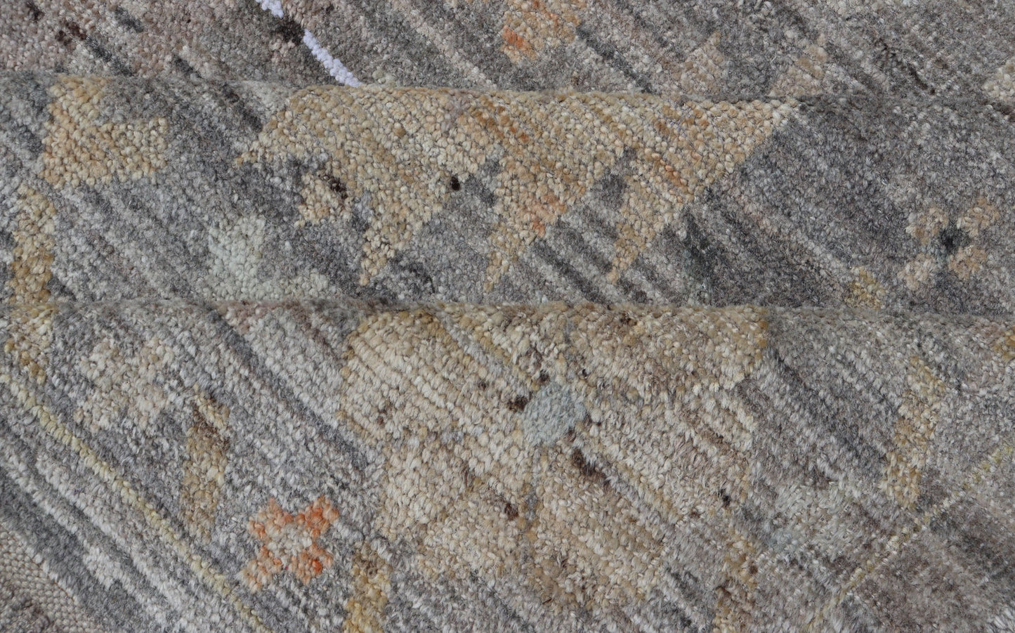 Modern Afghan Tribal Motif Designed Rug in Muted Tones and A Gray Background Measures 7'2 x 8'4 This modern area rug was hand - knotted in Afghanistan during the 2020's. This modern rug does feature a border of modest floral motifs. The gr... - Keivan Woven ArtsAFGC - 39487 - 18565Rug