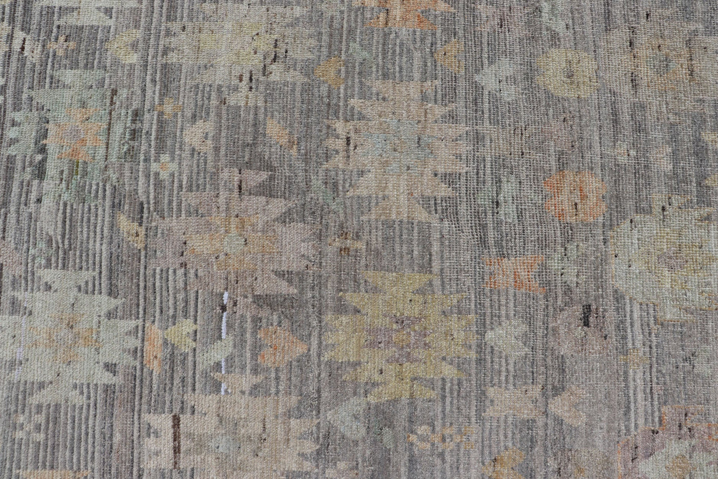 Modern Afghan Tribal Motif Designed Rug in Muted Tones and A Gray Background Measures 7'2 x 8'4 This modern area rug was hand - knotted in Afghanistan during the 2020's. This modern rug does feature a border of modest floral motifs. The gr... - Keivan Woven ArtsAFGC - 39487 - 18565Rug