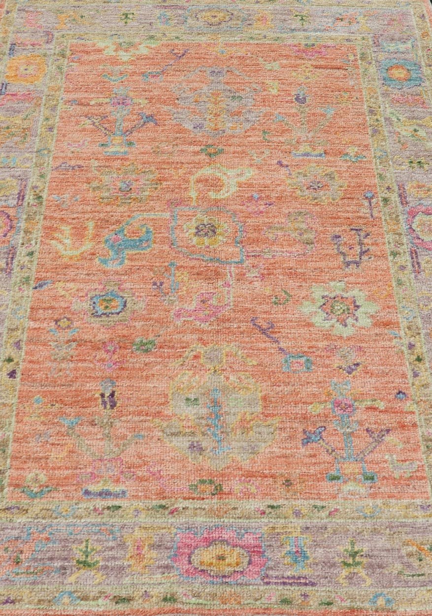 Hand Knotted Turkish Floral Oushak with Orange Background and Lilac Border This very unique piece has a wide array of bright colors, starting with a faded orange background and a light lilac border, showcasing fuchsia, electric blue, violet, or... - Keivan Woven ArtsAN - 149896 - 19941Rug