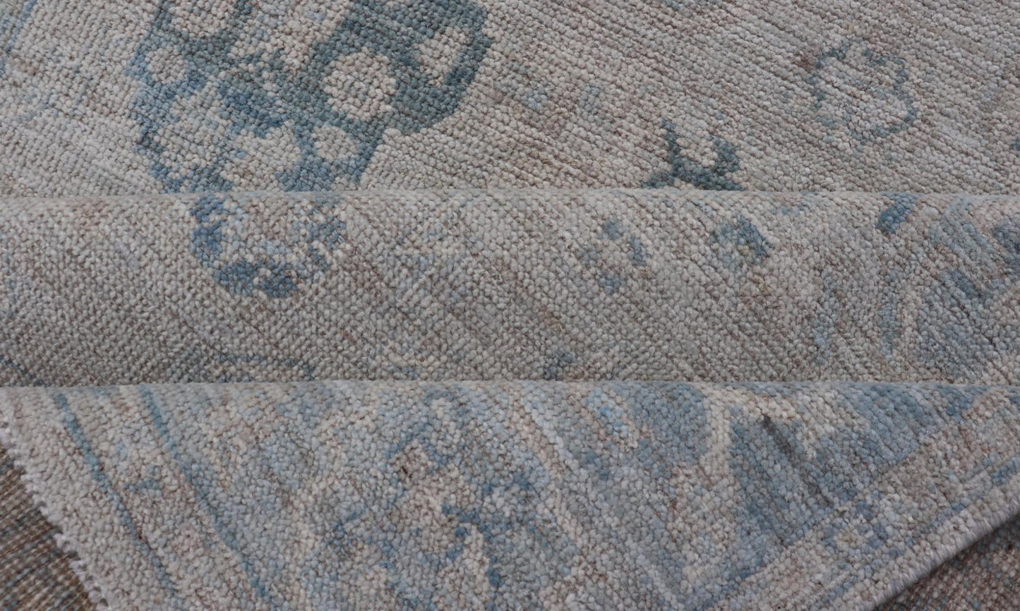 Hand - Knotted Oushak with A Light Blue Background and Tribal Motifs. Keivan Woven Arts; rug AWR - 10729 Country of Origin: Afghanistan Type: Oushak Design: Floral, All - Over Abstract - Tribal Measures: 4'0 x 5'4 This Oushak presents centered motif di... - Keivan Woven ArtsAWR - 10729 - 21627Rug