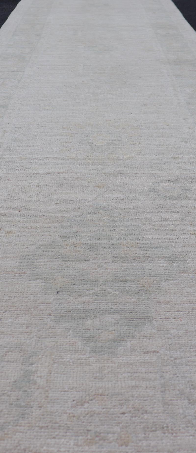 Hand - Knotted Oushak Runner with Medallion Design On A Cream Field With Blues. Keivan Woven Arts; rug AWR - 16727 Country of Origin: Afghanistan Type: Oushak Design: Medallion, Motif, Floral Motif. Measures: 2'8 x 11'10 This modern Oushak which ar... - Keivan Woven ArtsAWR - 16727 - 24294Rug