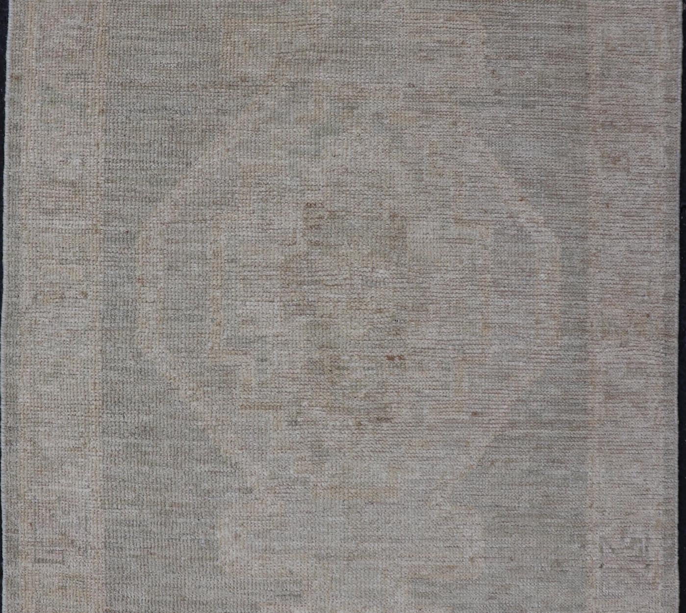 Modern Oushak with Off Gray Background with A Large Tribal Medallion in Cream. Country of Origin: Afghanistan; Type: Oushak; Design: Medallion, Tribal Medallion, All - Over; Keivan Woven Arts: rug AWR - 16772. 21st Century. Measures: 2'8 x 4'3 This... - Keivan Woven ArtsAWR - 16772 - 24444Rug