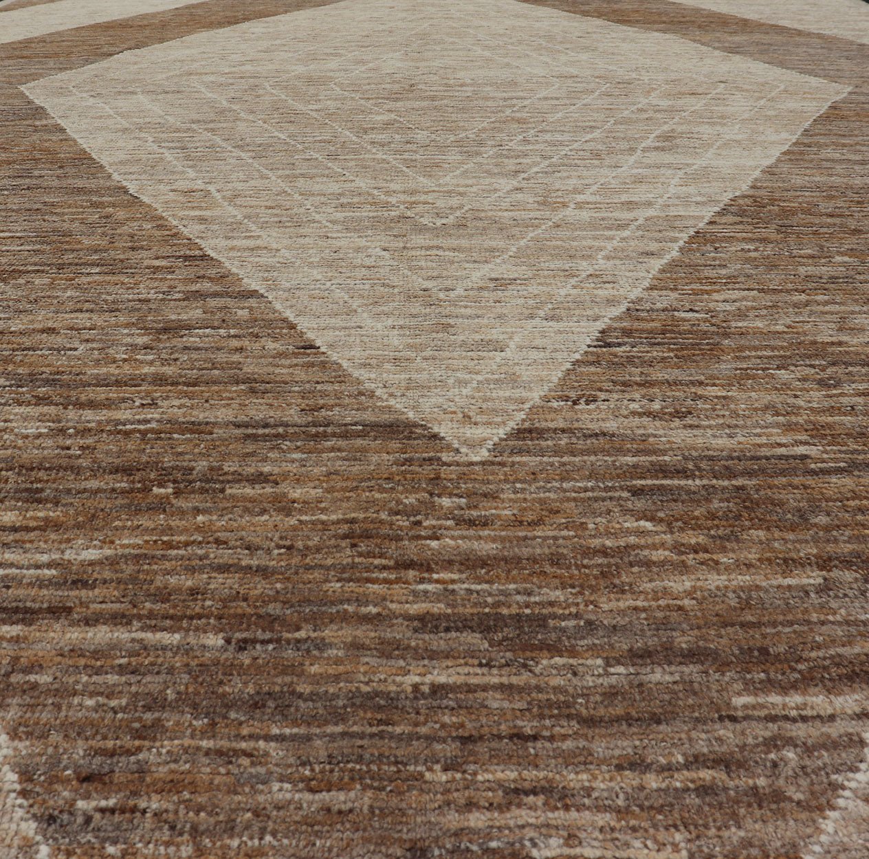 Measures: 10'6 x 14'1. This modern casual tribal rug has been hand - knotted in wool. The rug features a large modern diamond design, rendered in brown, tan, and cream; making this rug a superb fit for a variety of interiors. Modern Hand - Knotted Ru... - Keivan Woven ArtsAWR - 5004 - 17148Rug