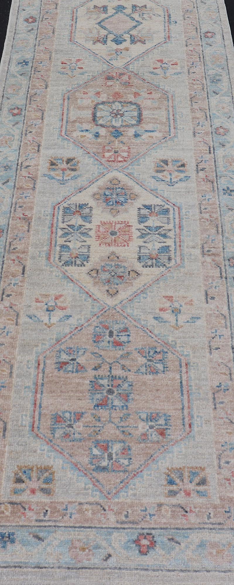 Hand - Knotted Oushak Runner with Medallion Design On A Cream Field With Blues This modern piece holds large medallions in the field, each of which are encasing floral - like motifs. The border is rendered in light blue and coral both embroidere... - Keivan Woven ArtsAWR - 6036 - 19977Rug