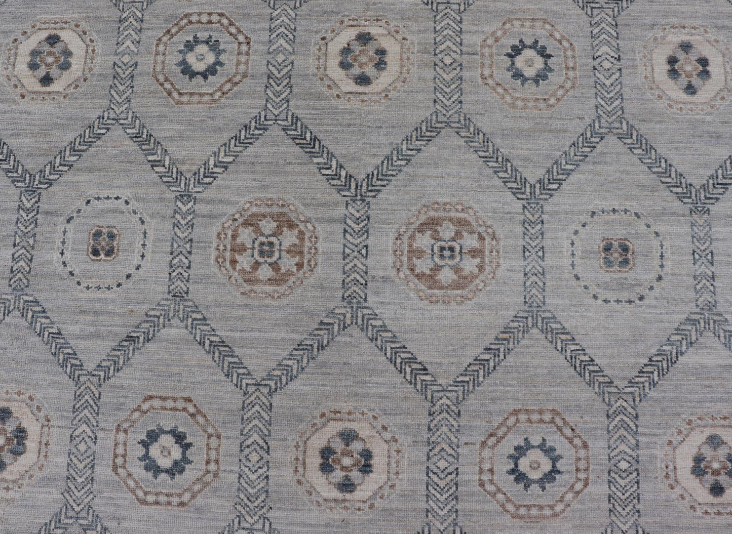 Sub - Geometric Mosaic Khotan Rug With Muted Tones of Blue and Brown This hand - knotted Khotan features geometric medallions, each of which hold a small geometric motif. The border hosts different geometric designs on each tier, alternating between... - Keivan Woven ArtsAWR - 6044 - 19989Rug