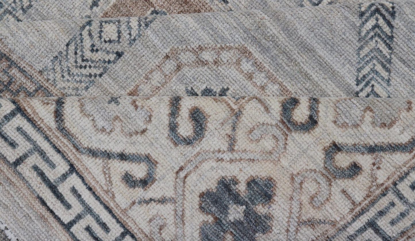Sub - Geometric Mosaic Khotan Rug With Muted Tones of Blue and Brown This hand - knotted Khotan features geometric medallions, each of which hold a small geometric motif. The border hosts different geometric designs on each tier, alternating between... - Keivan Woven ArtsAWR - 6044 - 19989Rug