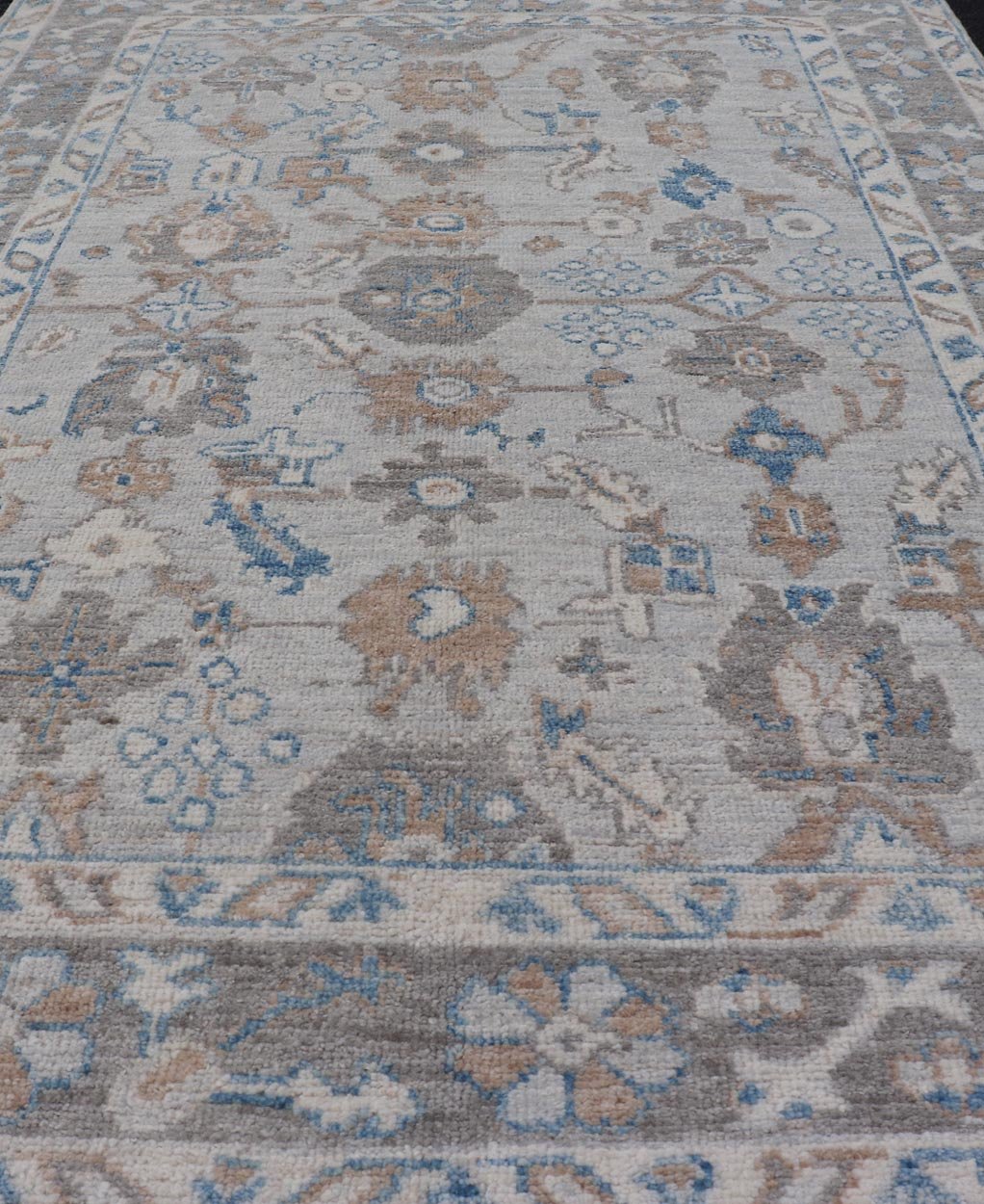 Hand - Knotted All - Over Floral Modern Oushak With Light Brown Border This beautiful contemporary piece starts with a floral border. The field has a modest silvery background with an all - over design rendered with earthy tones, such as wood brown, t... - Keivan Woven ArtsAWR - 6060 - 20001Rug