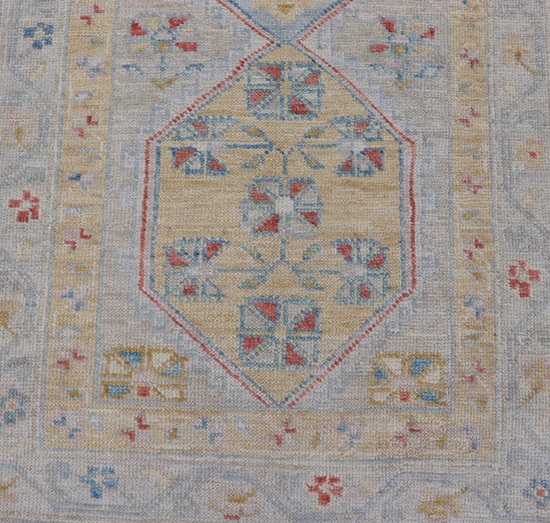 Hand - Knotted Floral Medallion Oushak Runner in Blue and Yellow This piece showcases brilliant medallions encasing star - like motifs in yellow, coral, orange, light blue, and cream. The border displays a yellow band between a cream background.... - Keivan Woven ArtsAWR - 6116 - 20013Rug