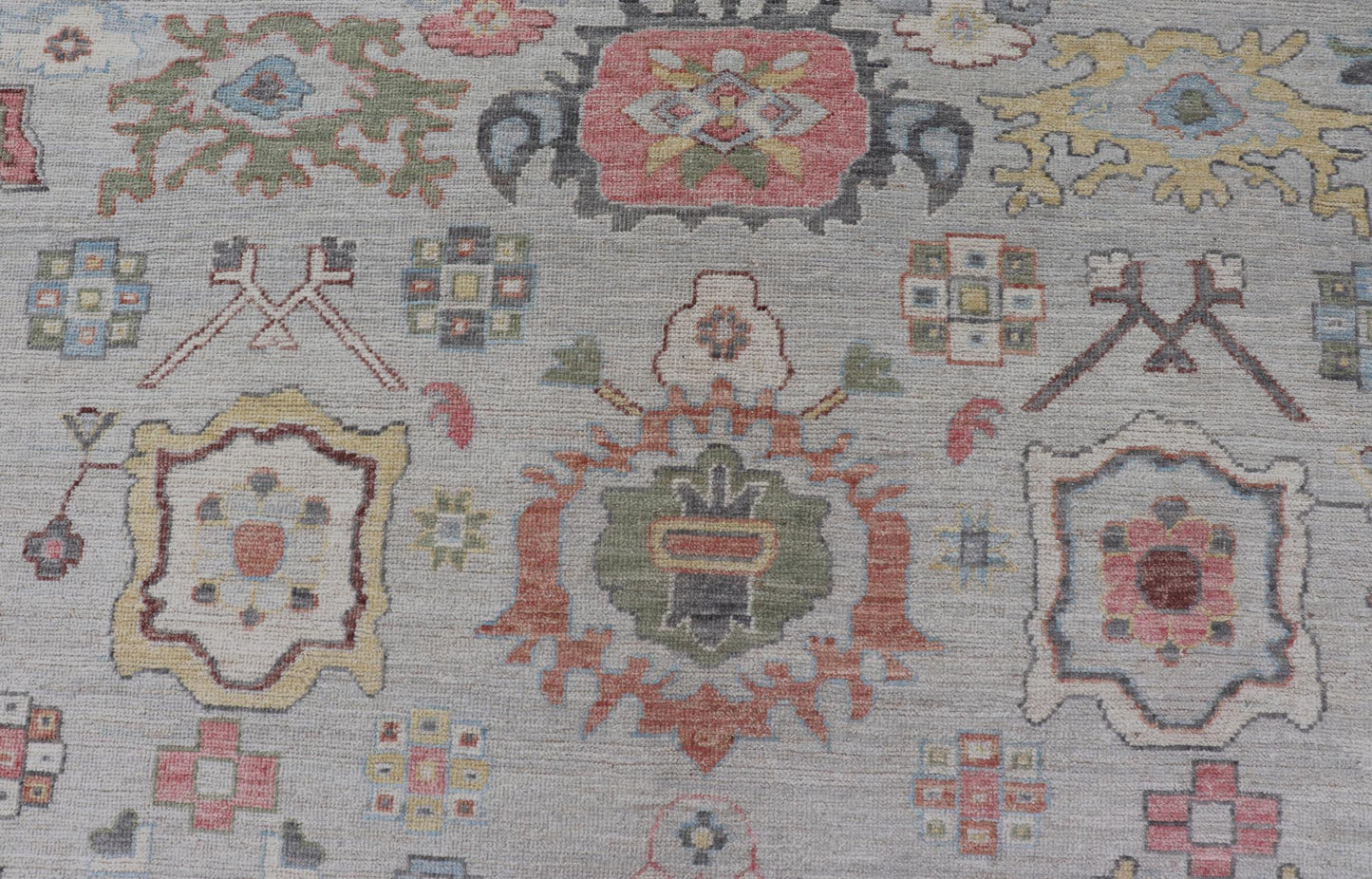 Oushak Floral Motif on Light Grey Background and Colorful Design The border and field are covered in floral - like motifs filled with colors such as pink, green, gold, teal and red - oranges on top of silvery grey background. The border showcases a ... - Keivan Woven ArtsAWR - 6148 - 20025Rug