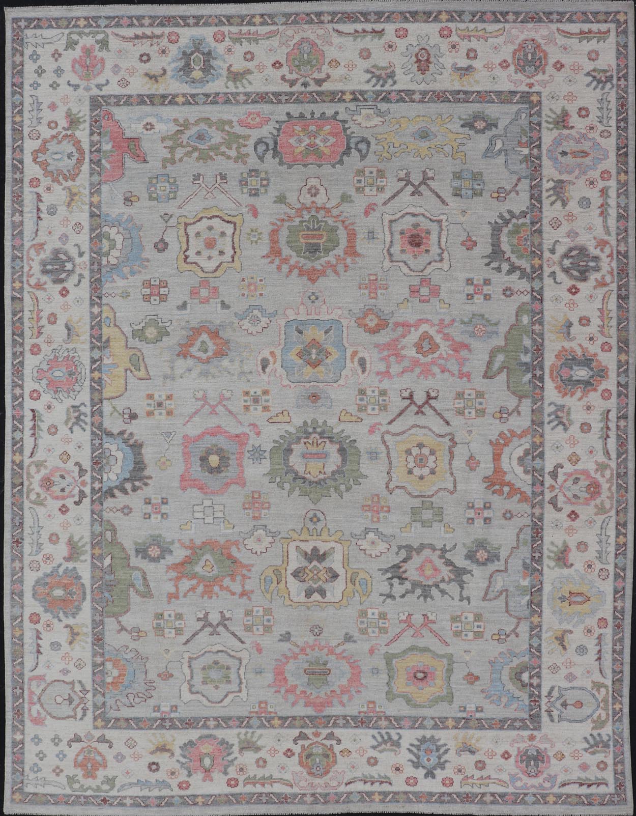 Oushak Floral Motif on Light Grey Background and Colorful Design The border and field are covered in floral - like motifs filled with colors such as pink, green, gold, teal and red - oranges on top of silvery grey background. The border showcases a ... - Keivan Woven ArtsAWR - 6148 - 20025Rug