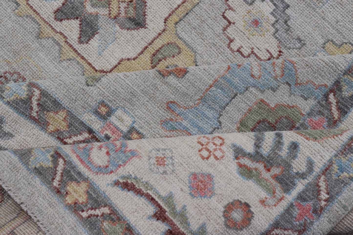 Oushak Floral Motif on Light Grey Background and Colorful Design The border and field are covered in floral - like motifs filled with colors such as pink, green, gold, teal and red - oranges on top of silvery grey background. The border showcases a ... - Keivan Woven ArtsAWR - 6148 - 20025Rug