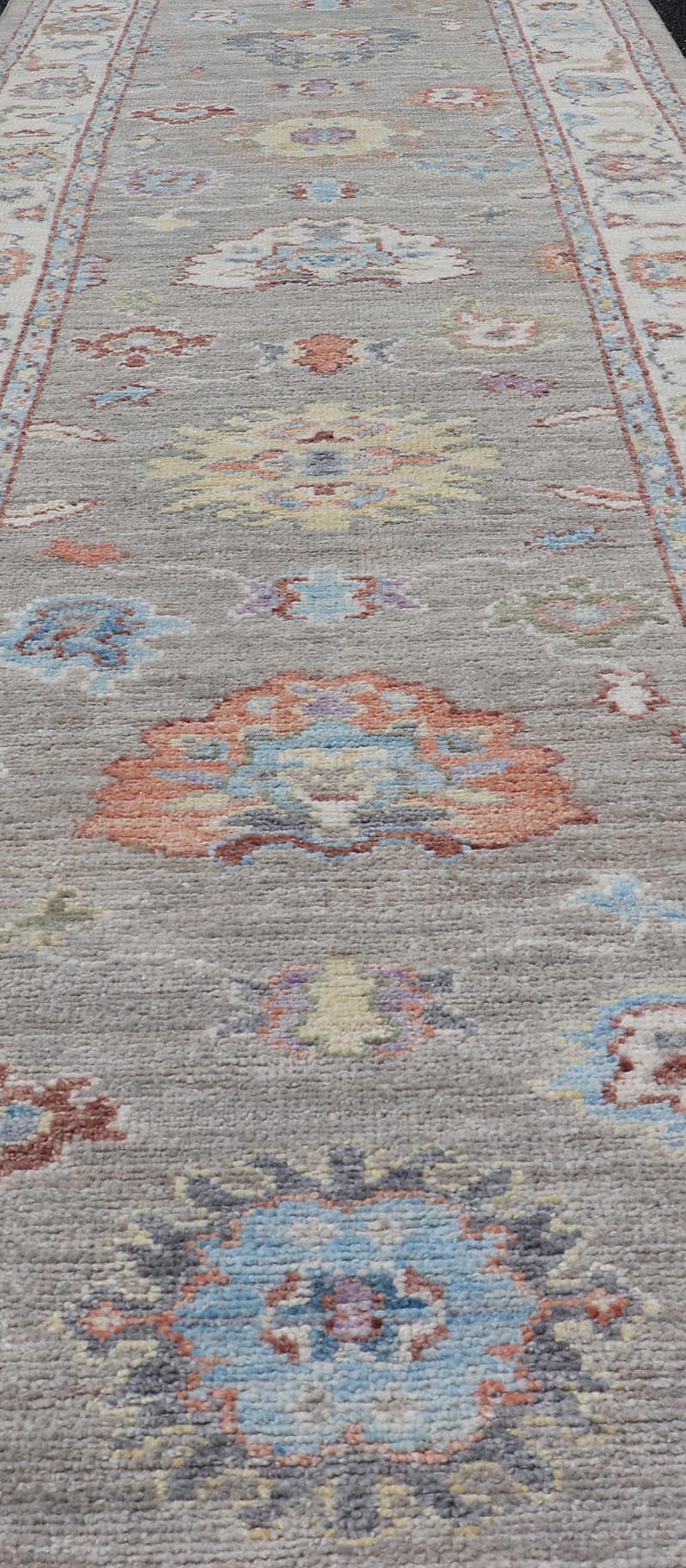 Hand - Knotted Modern Oushak Runner on Light Gray Field and Colorful Motifs This Oushak runner has been hand - knotted. The arabesque motifs scatter atop a light gray background. Within the field, bright displays of gold, teal, blue, pink, maroon, ... - Keivan Woven ArtsAWR - 6196 - 19899Rug