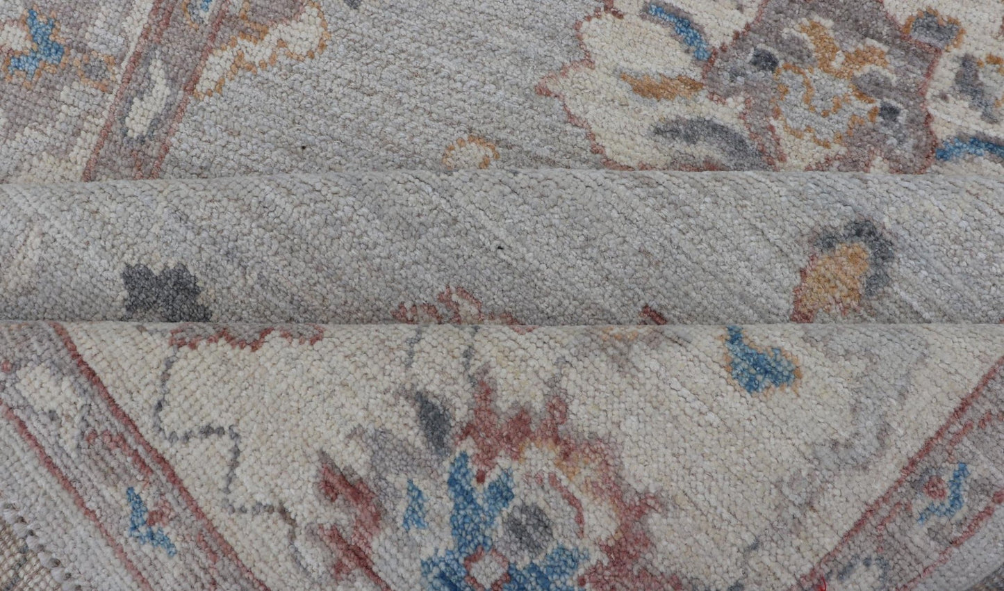 Floral Modern Oushak With Muted Gray Background and Cream Border This piece gives a modern vibrancy to the classic floral Oushak design. With a louder light gray background, the field showcases bold accents of cream and taupe in a half - floral, ... - Keivan Woven ArtsAWR - 6287 - 20031Rug