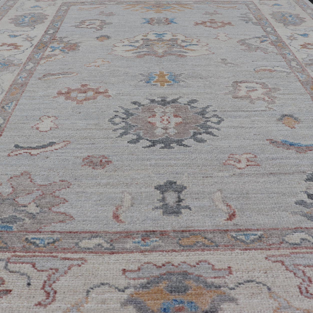 Floral Modern Oushak With Muted Gray Background and Cream Border This piece gives a modern vibrancy to the classic floral Oushak design. With a louder light gray background, the field showcases bold accents of cream and taupe in a half - floral, ... - Keivan Woven ArtsAWR - 6287 - 20031Rug
