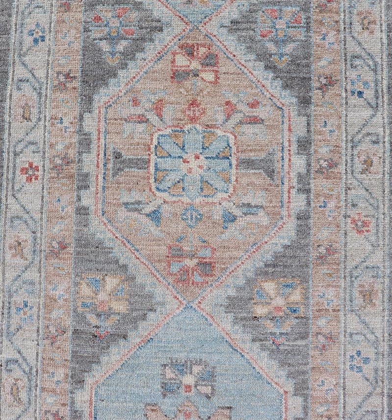Floral Medallion Oushak Runner With Tribal Motifs and On A Gray Background This Hand - Knotted Afghan Oushak presents a double - lined floral border on top of a dark taupe background, accenting colors such as blue, red, and peach. The field disp... - Keivan Woven ArtsAWR - 6296 - 19905Rug
