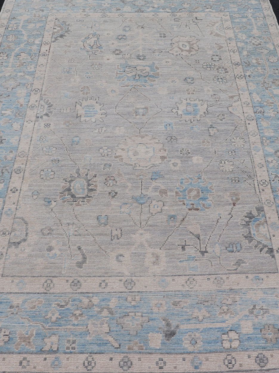 Hand - Knotted Light Blue Oushak with Light Gray Background Hand - Knotted in Afghanistan, this rustic piece holds charm within a powder blue border and a light gray field background. Above lays a modest Oushak - styled floral design reaching all ... - Keivan Woven ArtsAWR - 6309 - 20049Rug