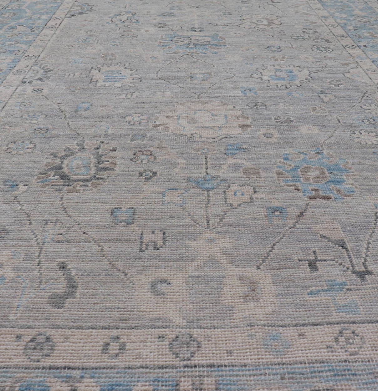 Hand - Knotted Light Blue Oushak with Light Gray Background Hand - Knotted in Afghanistan, this rustic piece holds charm within a powder blue border and a light gray field background. Above lays a modest Oushak - styled floral design reaching all ... - Keivan Woven ArtsAWR - 6309 - 20049Rug