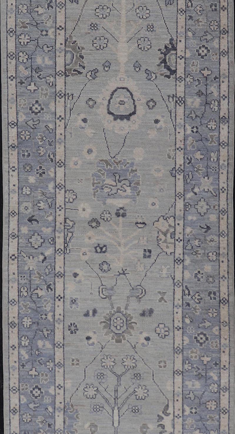 Modern Oushak Design With Light Blue Background and All - Over Design This Afghan runner features a classic Oushak look, showing off brilliant floral motifs and vines reaching all over the field against a cool gray and pewter background. Central ... - Keivan Woven ArtsAWR - 6325 - 20061Rug