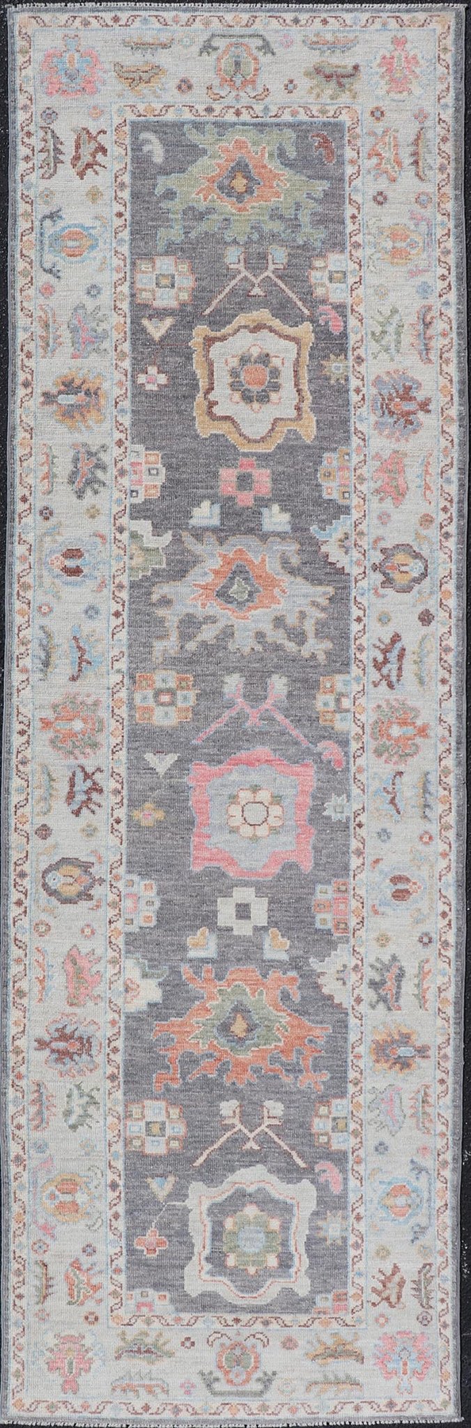 Hand Knotted Afghan Oushak Designed Runner with Gray Background This Afghan Oushak runner features a grand motif, showcasing from the border to the field with a vibrant elegance that pops against the light blue - gray border, as well as the charc... - Keivan Woven ArtsAWR - 6463 - 19911Rug