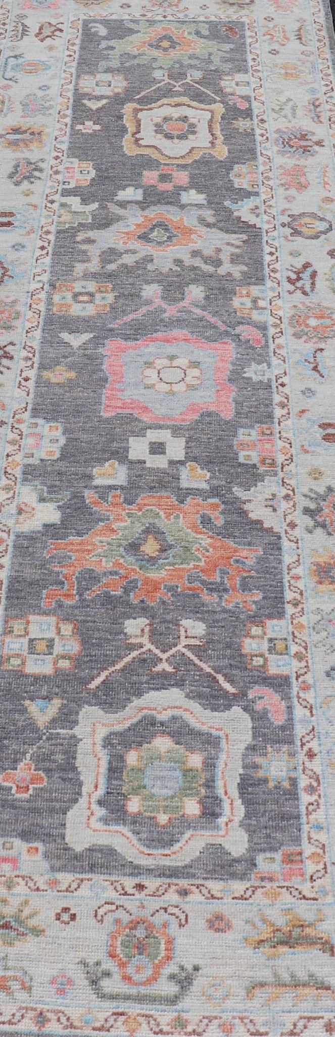 Hand Knotted Afghan Oushak Designed Runner with Gray Background This Afghan Oushak runner features a grand motif, showcasing from the border to the field with a vibrant elegance that pops against the light blue - gray border, as well as the charc... - Keivan Woven ArtsAWR - 6463 - 19911Rug