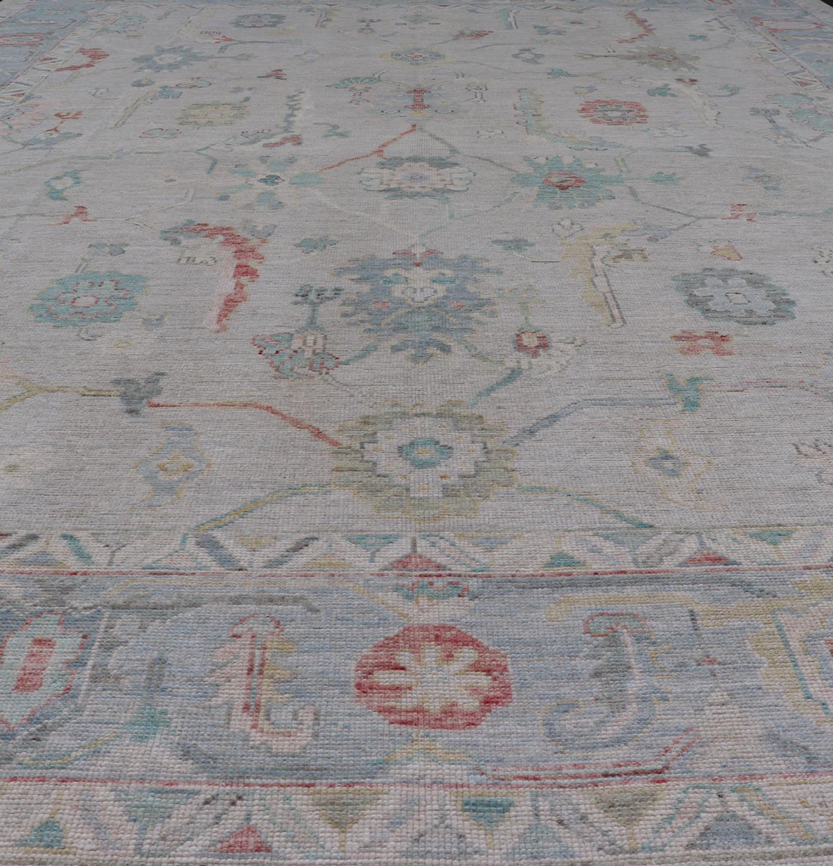 Large Modern Oushak with floral design on light blue/gray border with pops of color. Keivan Woven Arts; rug AWR - 9004 Country of Origin: Afghanistan Type: Oushak Design: Mosaic Floral, All - Over. 21st century. Measures: 10'1 x 13'10. The fi... - Keivan Woven ArtsAWR - 9004 - 21311Rug