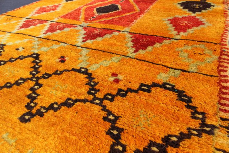 Saffron Colored Antique Moroccan Carpet with Tribal Geometric Design Keivan Woven Arts Measures: 4'4'' x 6'6''. Crafted in the mid - 20th century, this gorgeous Antique Moroccan Rug bears a body of saffron and soft orange and golden hues. Fi... - Keivan Woven ArtsBDS - 136603 - 7267Rug