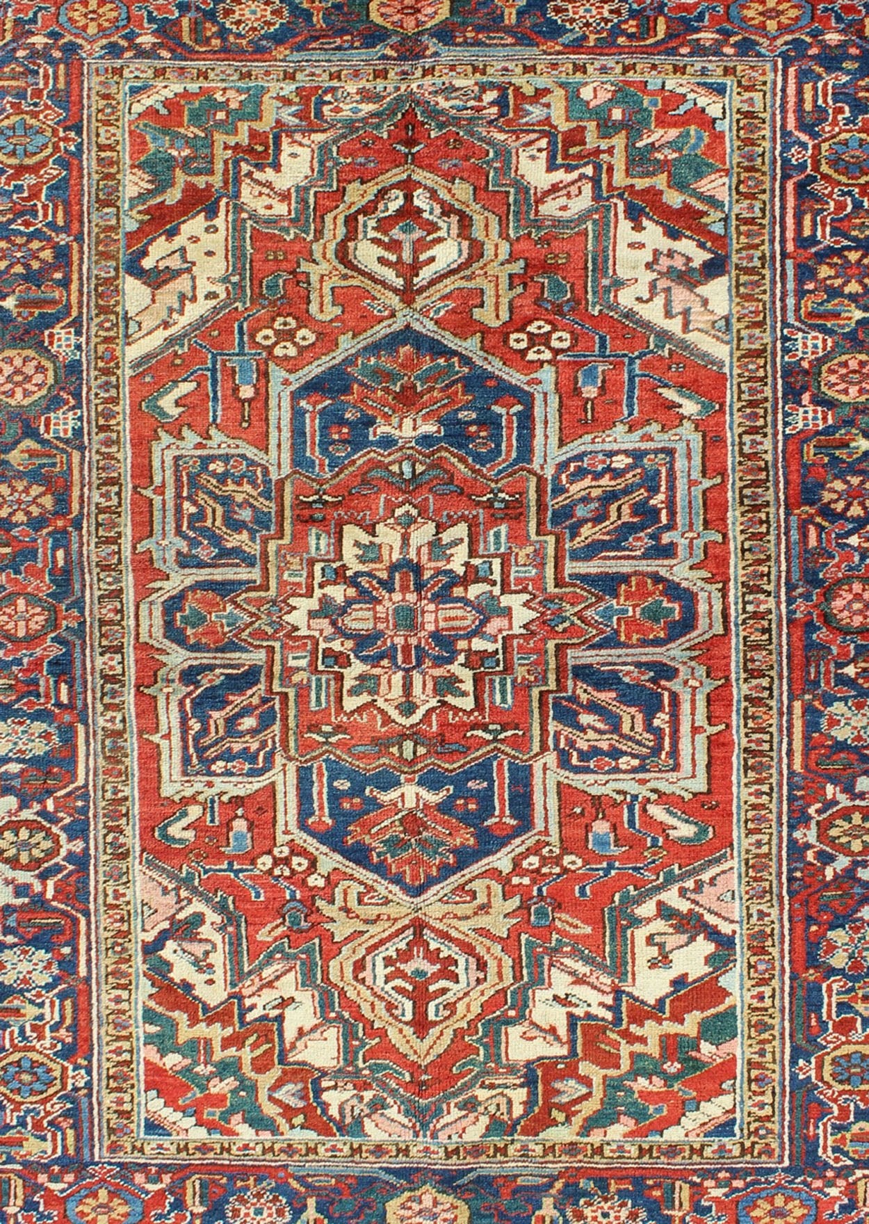 Antique Heriz - Serapi Rug This antique Persian Heriz - Serapi from the early 20th century bears an exquisite design rendered in gorgeous, warm hues of red and denim blue. A highly stylized geometric center medallion anchors the piece and is surroun... - Keivan Woven ArtsD - 0908 - 2205Rug