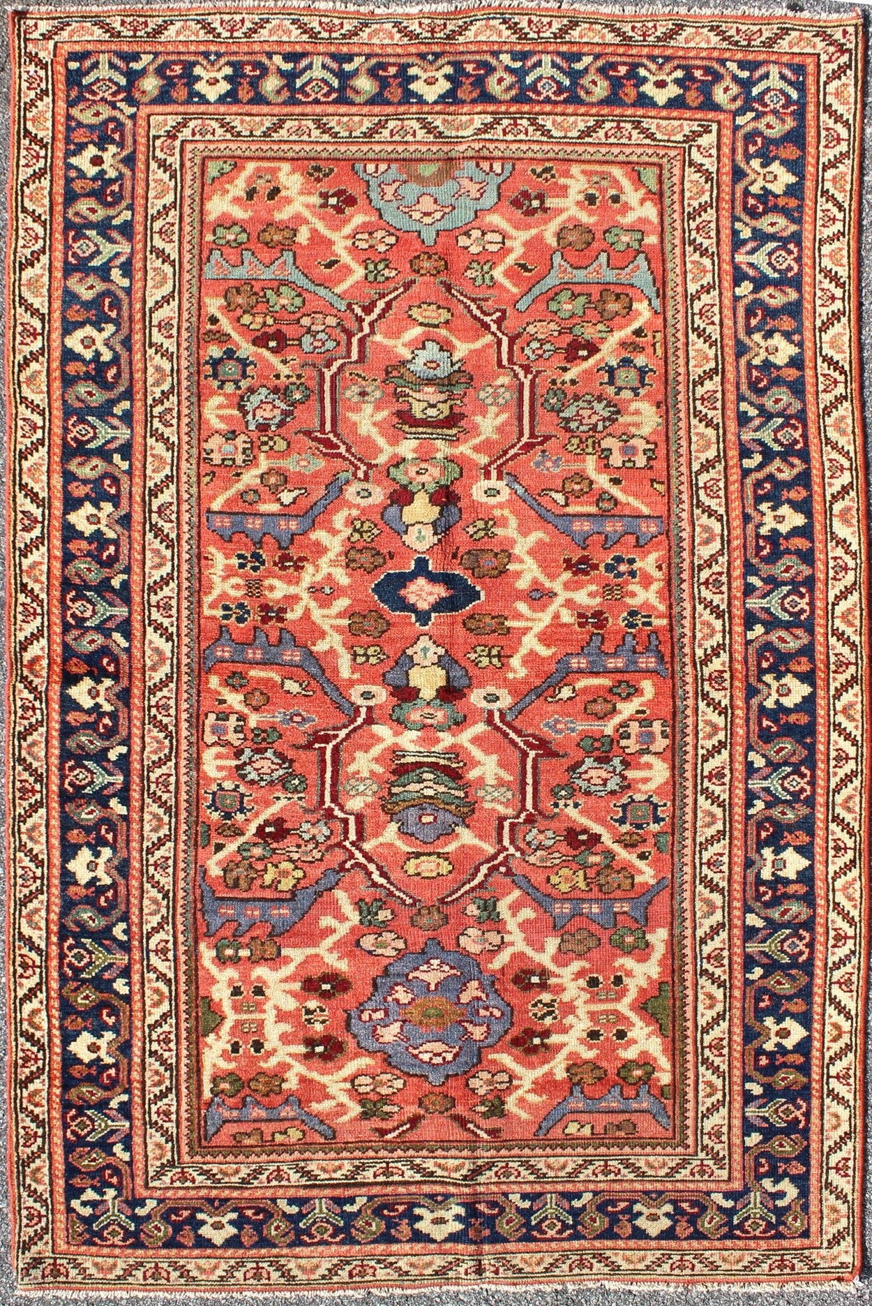Antique Persian Sultanabad Rug A beautiful Sultanabad rug, this piece features a cinnamon - shaded field bearing an intricate floral motif of repeating red, light purple and pink flowers. A thin blue border displays straight rows of single blossom... - Keivan Woven ArtsD - 0924 - 1847Rug