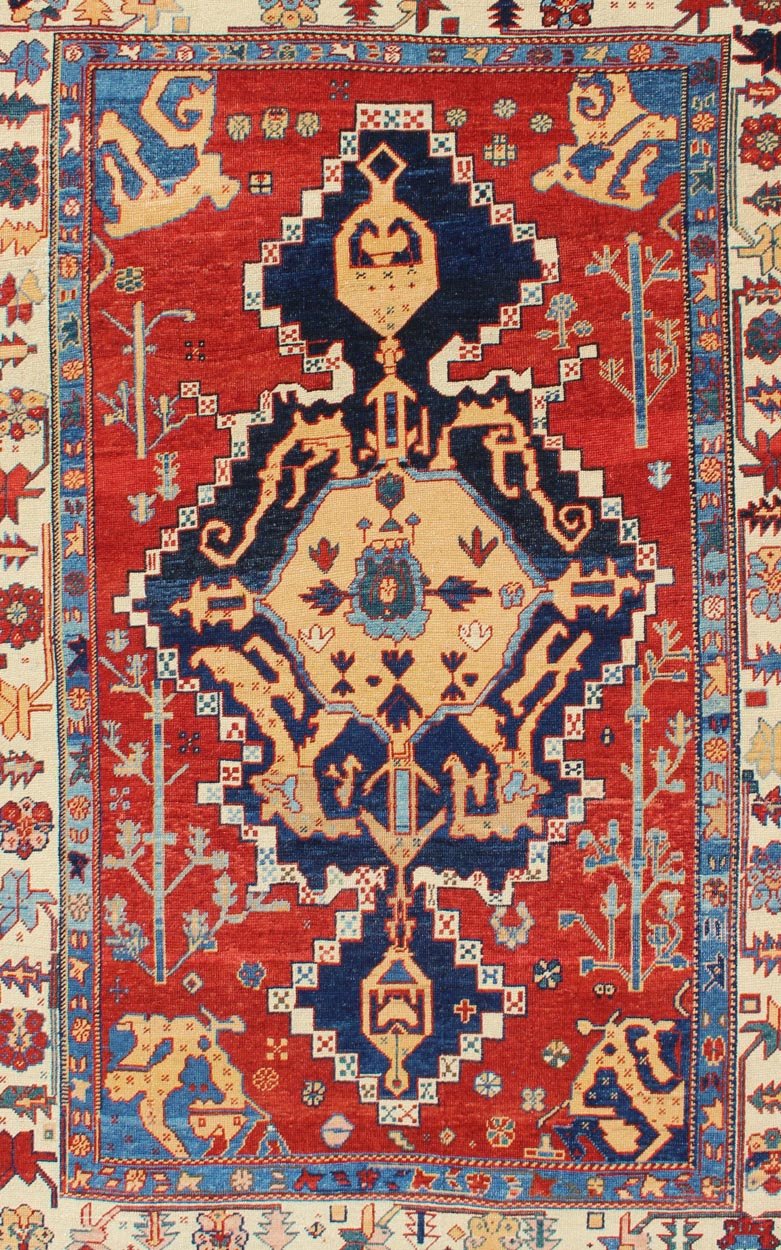 Vintage Turkish Tribal Rug with Jewel - Toned Central Medallion and Vivid Border This vintage Turkish Tribal rug features a large central medallion and a jewel - toned geometric design surrounded by a vivid blue and ivory border. Measures: 4'9 x ... - Keivan Woven ArtsDSP - WL30362 - 4134Rug