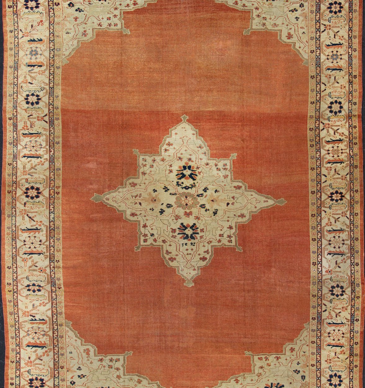 Large Antique Ziegler Sultanabad rug with central medallion in soft orange, ivory and pops of navy blue. Keivan Woven Arts / E - 1207. Late 19th Century Persian Antique Ziegler, antique Persian Ziegler. Measures: 10'2 x 14'5 This striking antique Z... - Keivan Woven ArtsE - 1207 - 1827Rug