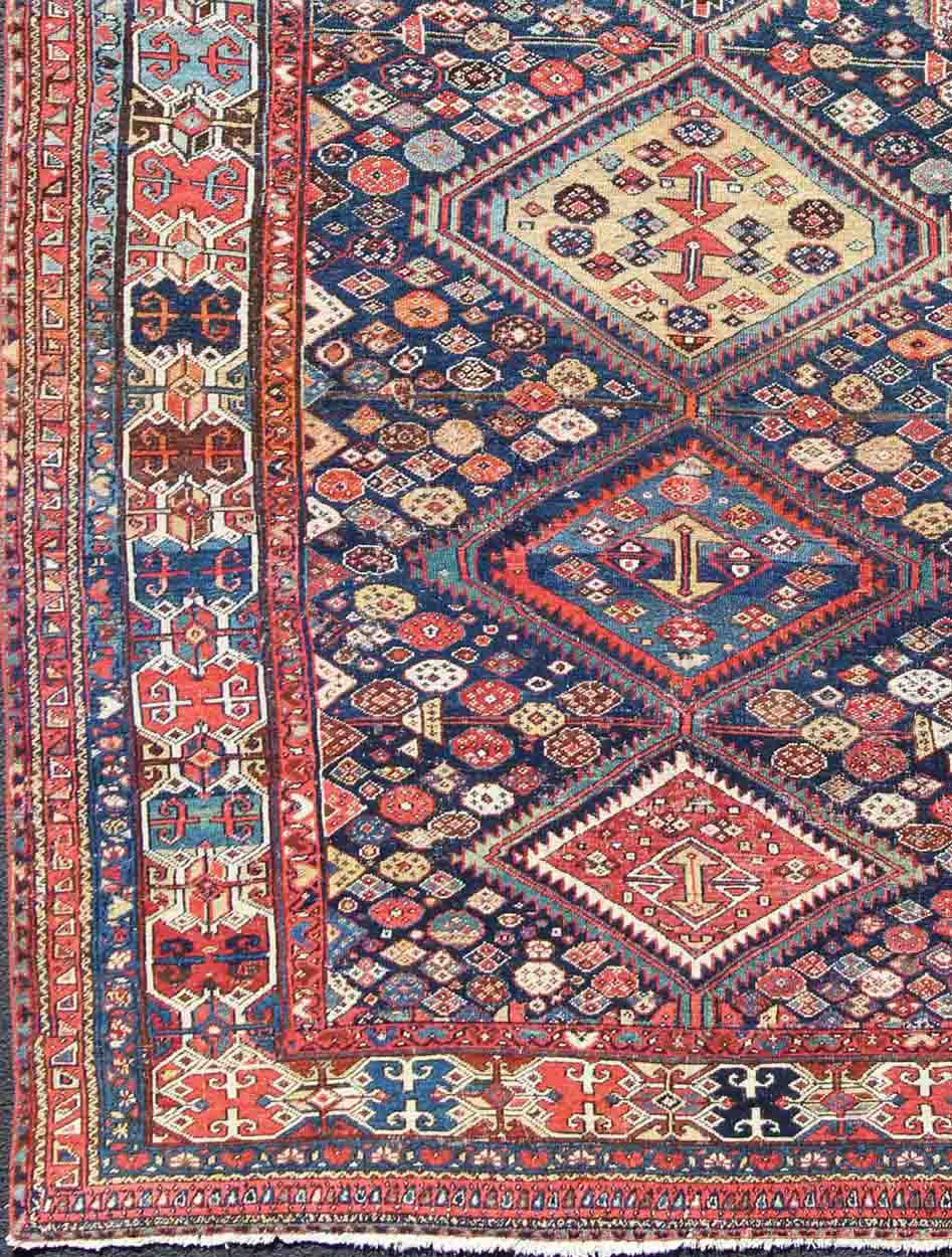 Blue and red antique Persian Hamedan rug with vertical diamond multi - medallions, rug ema - 7563, country of origin / type: Iran / Hamedan, circa 1890. This magnificent antique Hamedan features beautiful coloration, including tones of blue, red, nu... - Keivan Woven ArtsEMA - 7563 - 9820Rug