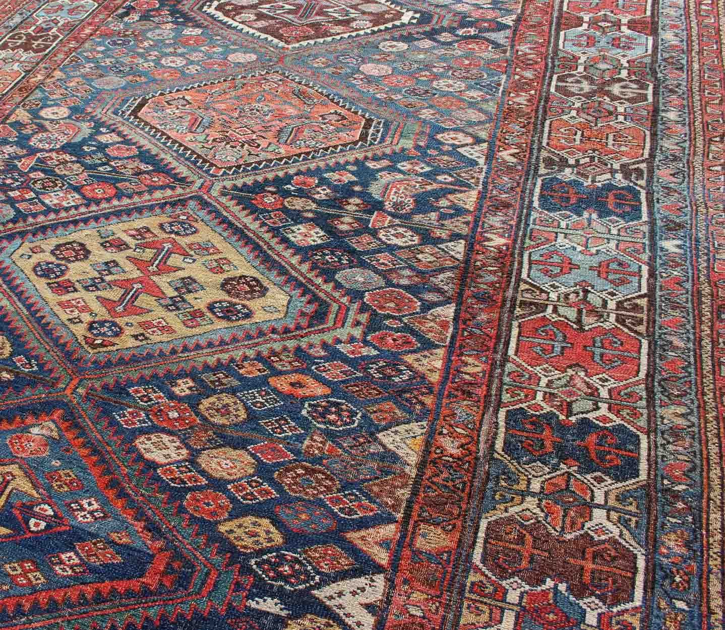 Blue and red antique Persian Hamedan rug with vertical diamond multi - medallions, rug ema - 7563, country of origin / type: Iran / Hamedan, circa 1890. This magnificent antique Hamedan features beautiful coloration, including tones of blue, red, nu... - Keivan Woven ArtsEMA - 7563 - 9820Rug