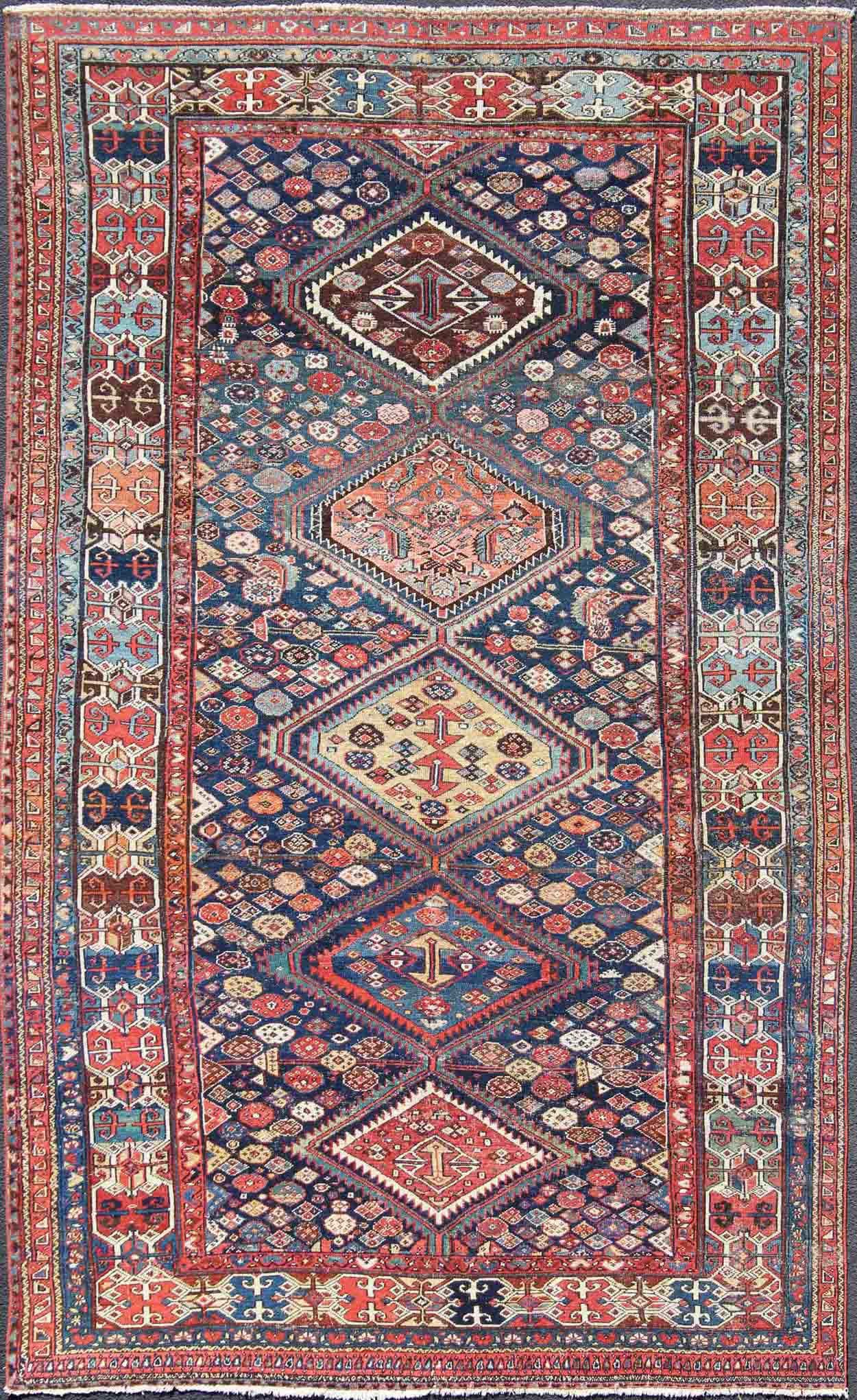 Blue and red antique Persian Hamedan rug with vertical diamond multi - medallions, rug ema - 7563, country of origin / type: Iran / Hamedan, circa 1890. This magnificent antique Hamedan features beautiful coloration, including tones of blue, red, nu... - Keivan Woven ArtsEMA - 7563 - 9820Rug