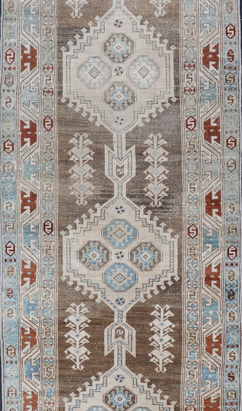 Long Persian Heriz Runner with Central Medallions in Brown, Blue, Tan & Red. Antique Heriz Persian long runner with multi - medallion and geometric design from Persia, rug EMA - 7568 , country of origin / type: Iran / Heriz, circa 1920 This m... - Keivan Woven ArtsEMA - 7568 - 9838Rug