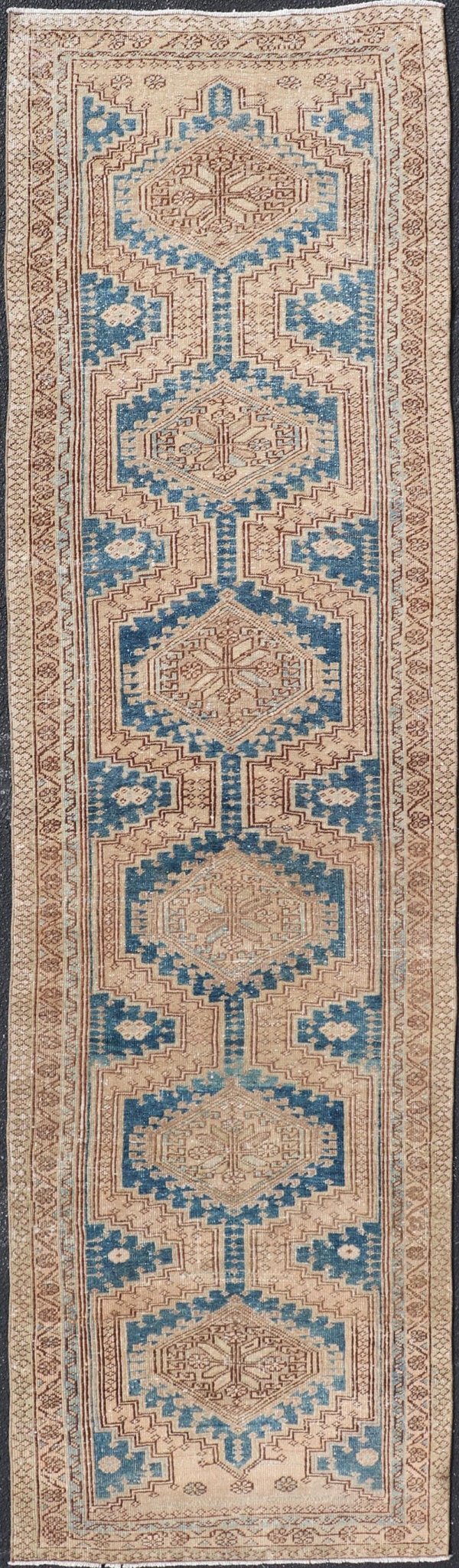 Measures: 3'0 x 10'10 This antique Persian Heriz runner with a distinctive and elegant design. The runner showcases a series of connected geometric medallions running along its length, each intricately detailed with traditional motifs. The central ... - Keivan Woven ArtsEMB - 22240 - 22484Rug